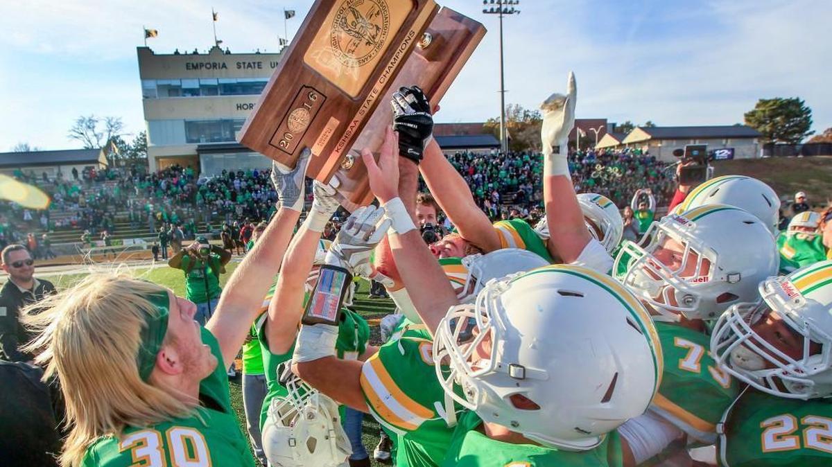 Derby players hoist the championship trophy after defeating Blue Valley 17-14 at the 2016 Class 6A championship game in Emporia.