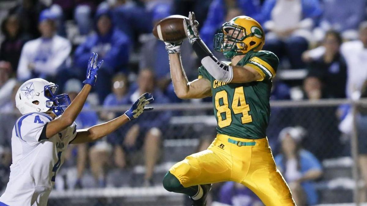 Bishop Carroll's Thomas Helton hauls in a TD reception against Kapaun's Jarius Kennedy in the second quarter Friday at Carroll.