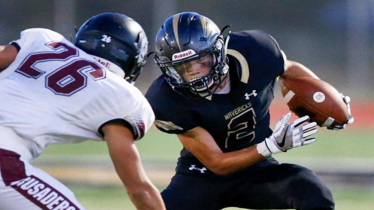 Maize South’s Corey Minks tries to evade Buhler’s Sam Cruz on Friday night. Buhler knocked off unbeaten Maize South and moved up to No. 4 in the Class 4A-I rankings.