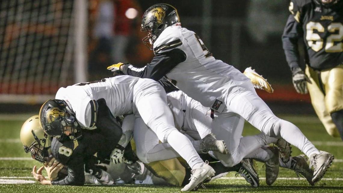 Andover Central QB Reagan Jones is sacked by Maize South's Jack Wagner and Korban Trapp in the second quarter Friday in Andover.