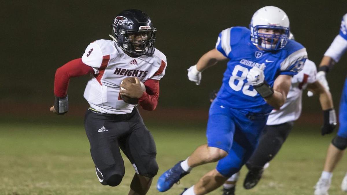 Heights quarterback K’Vonte Baker heads upfield against Kapaun in the first half Friday.