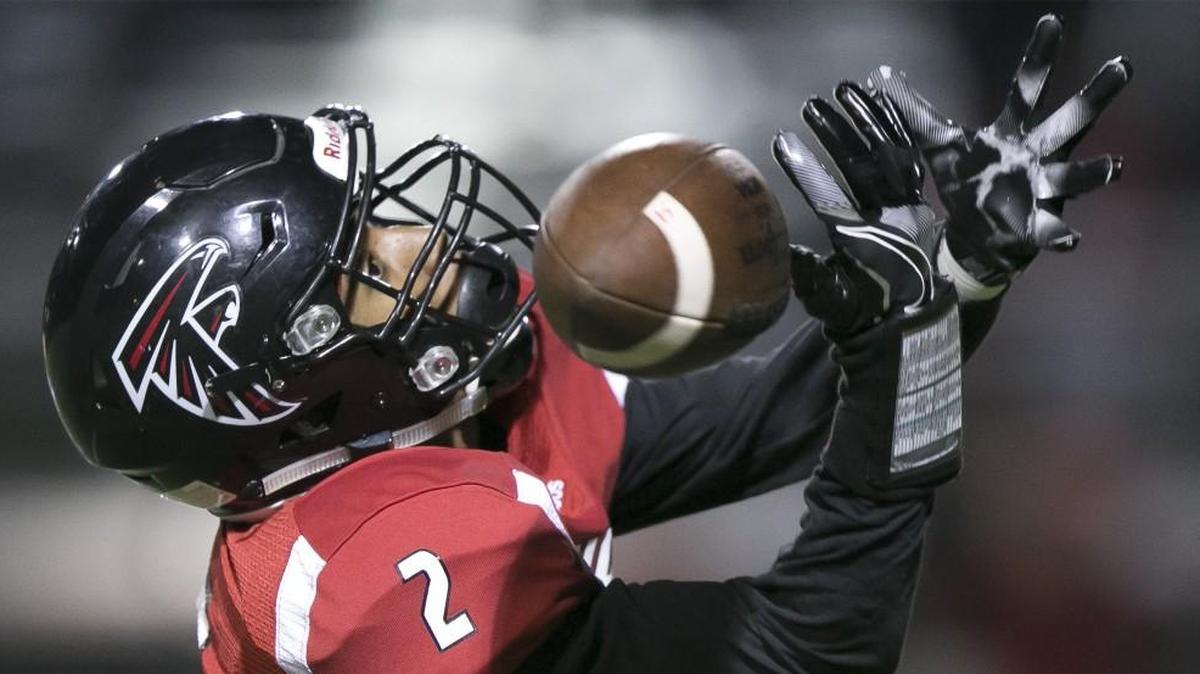 Heights' Braxton Kirkendoll tries to grab a long pass against Bishop Carroll in the second quarter Friday.