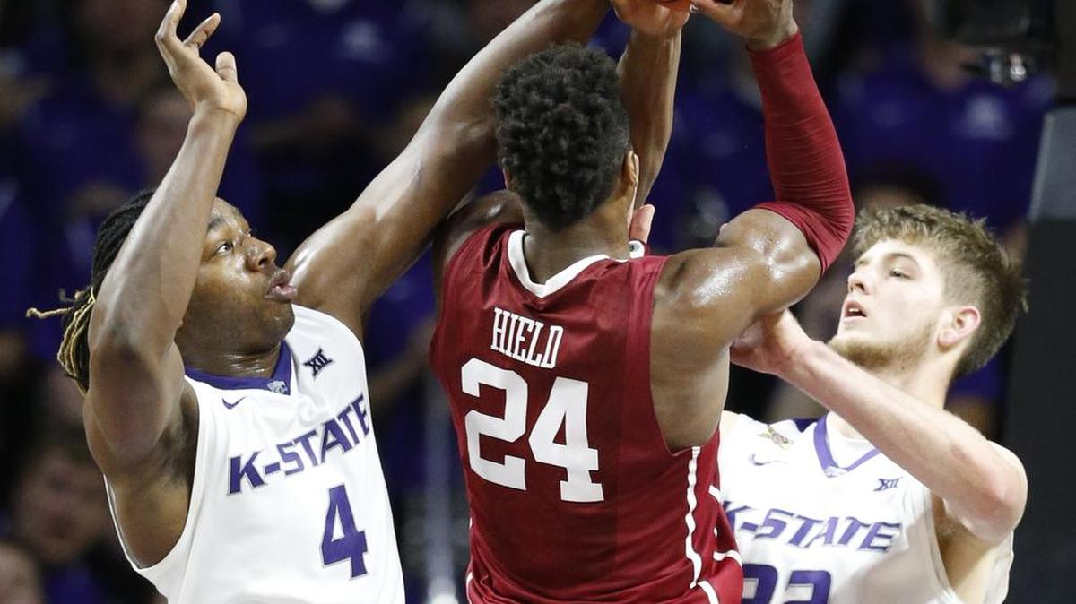K-State forward D.J. Johnson (4) and forward Dean Wade (32) shut down Oklahoma guard Buddy Hield (24) Saturday as K-State upset #1 Oklahoma . (February 6, 2016)