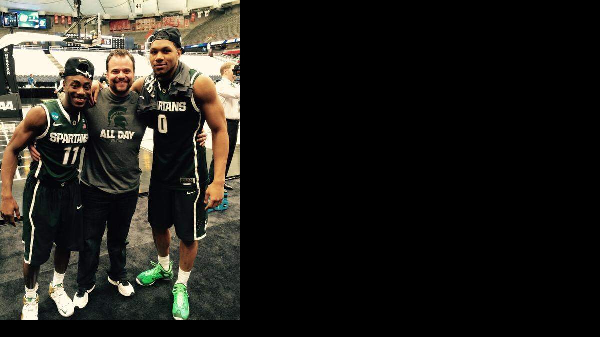 
Michigan State freshmen Lourawls Nairn, left, and Marvin Clark, right, celebrate the Spartans’ Final Four berth with their former coach, Sunrise Christian’s Kyle Lindsted. Michigan State beat Louisville 76-70 in overtime in the Elite Eight.
